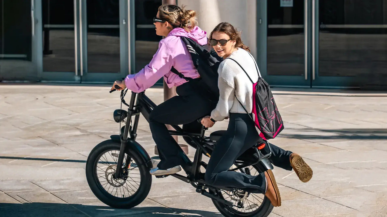 Cyclists on a class 2 electric bike riding through a California bike lane under 2025 traffic rules