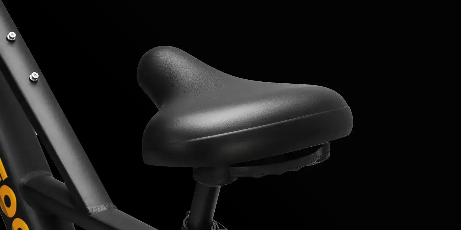 Close-up of a black cushioned e-bike saddle on a modern electric bike frame, designed for enhanced comfort during long rides.
