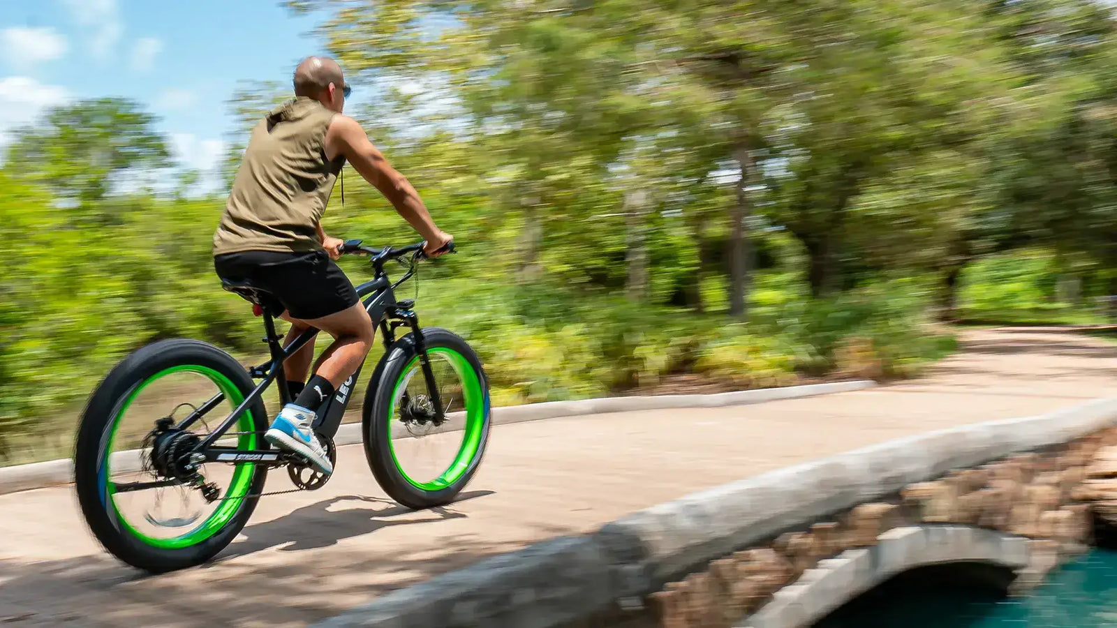 Rider on one of the fastest e bikes under 2000 with green-rim fat tires.