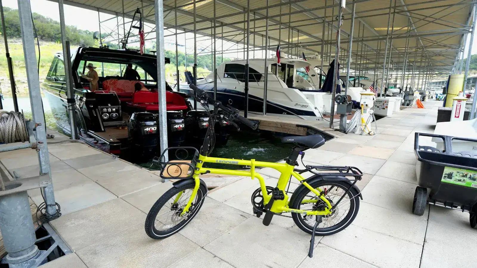 Affordable electric bike parked among expensive vehicles in a parking area
