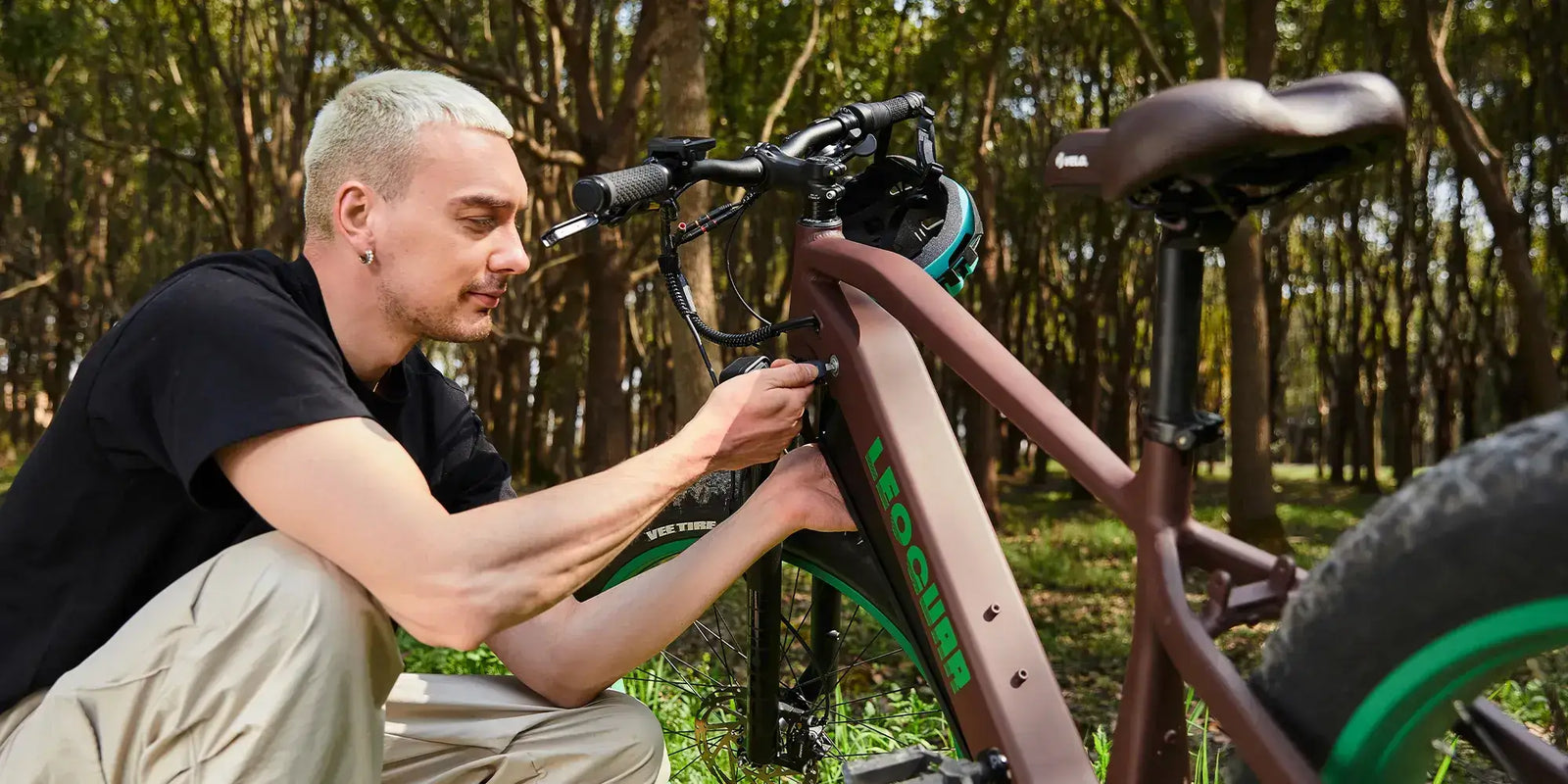 Man inspecting e-bike lock area, searching for a lost key solution.