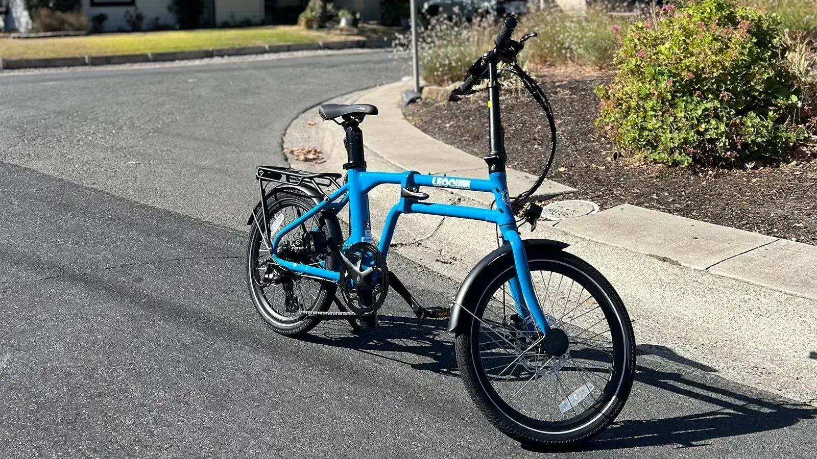Street legal ebike parked on the road showing compliant design with pedals and lights