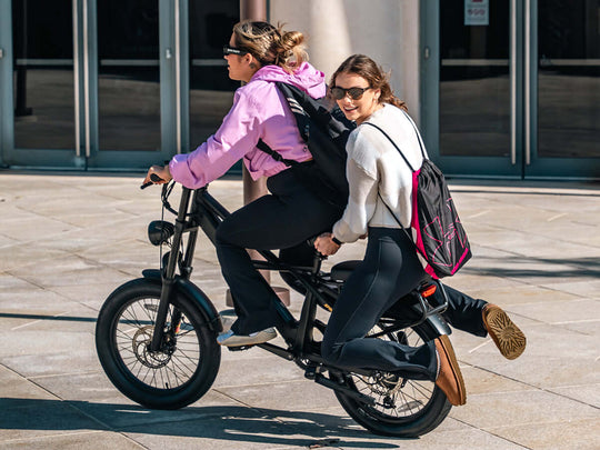 Two women riding a Sprint Fat Tire Utility Ebike.