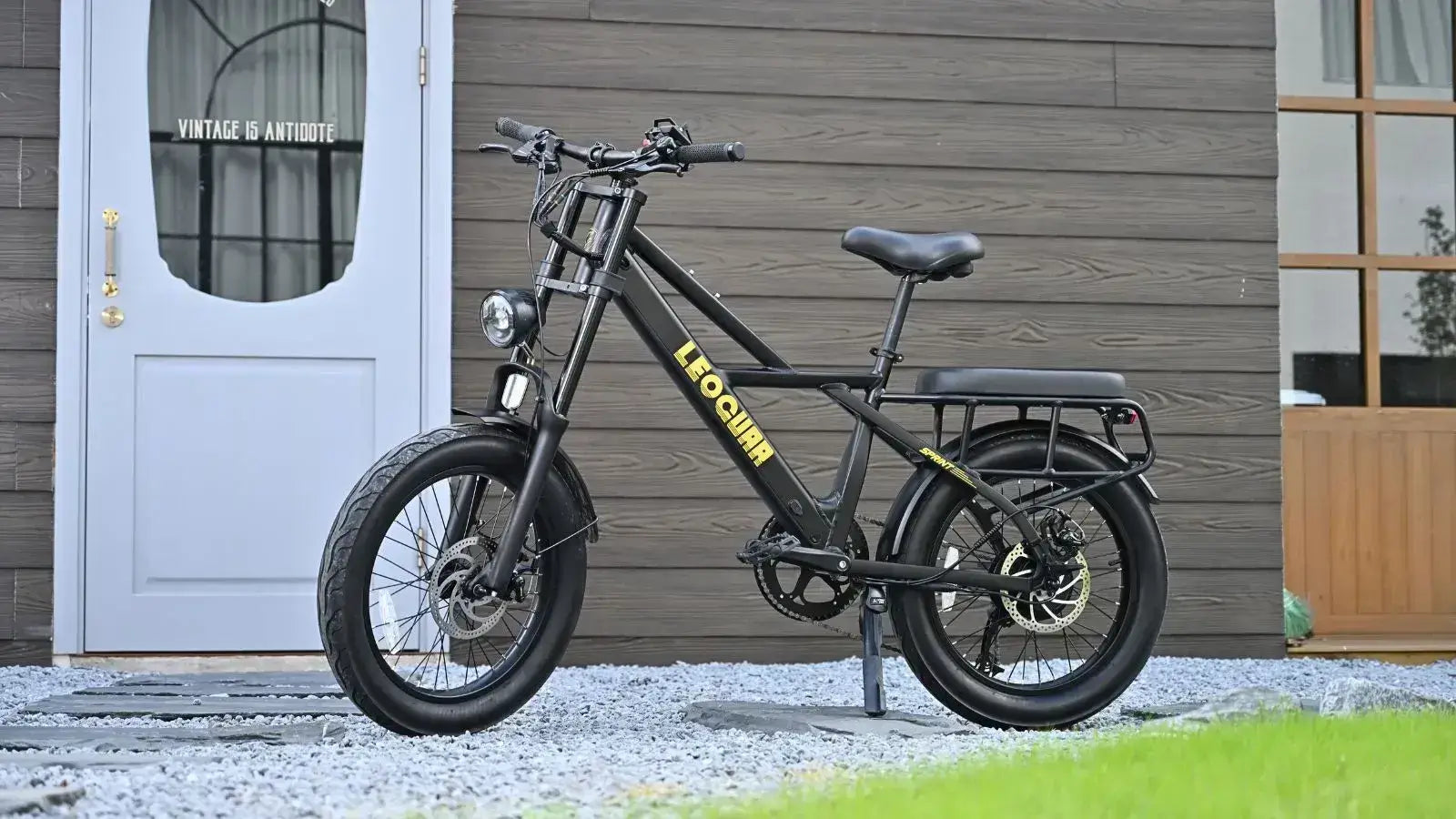 what's the best ebike for the price: sleek black ebike parked outside a modern house.