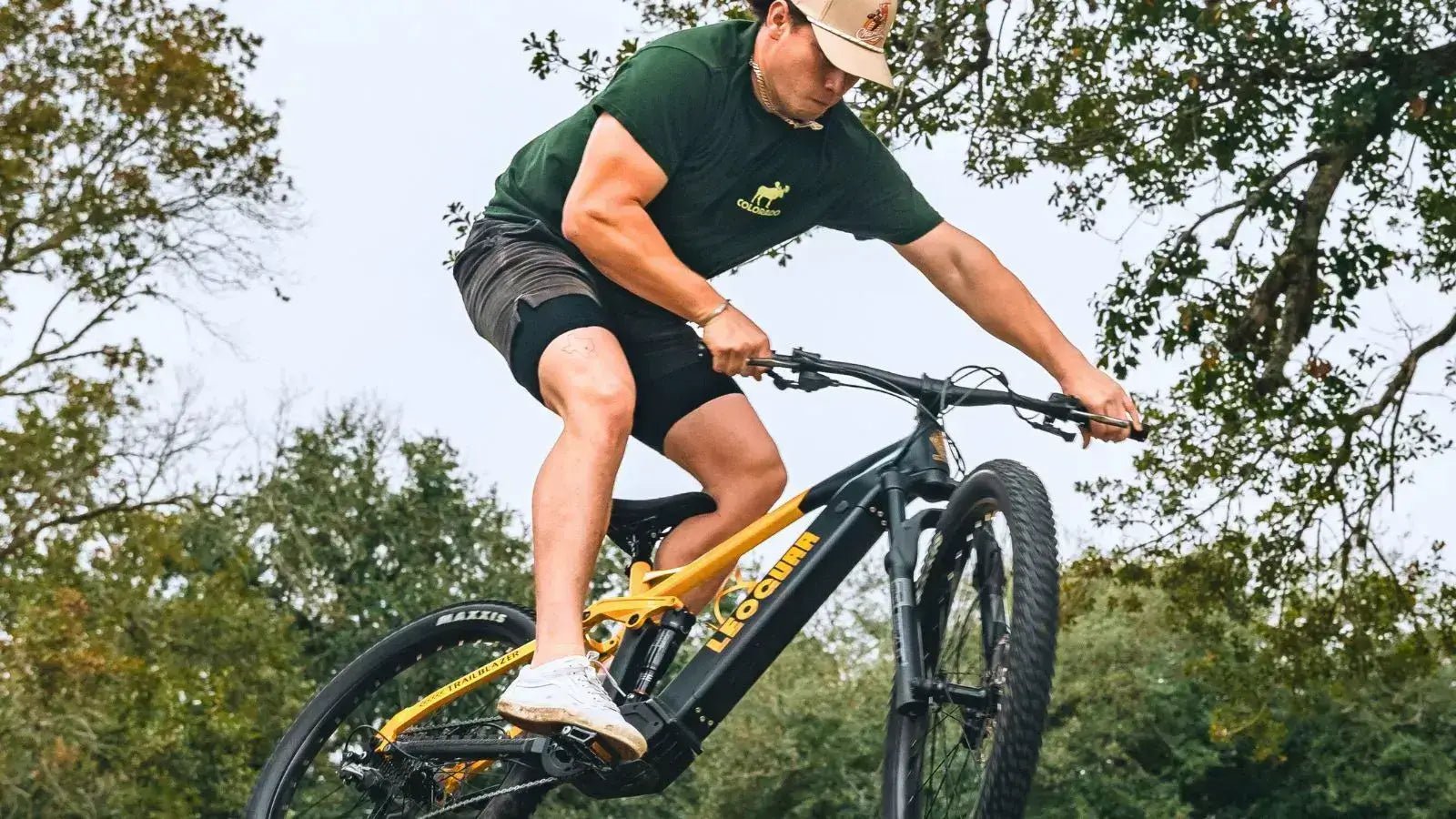 Person performing a jump on an electric bike, highlighting motors for electric bikes in action.