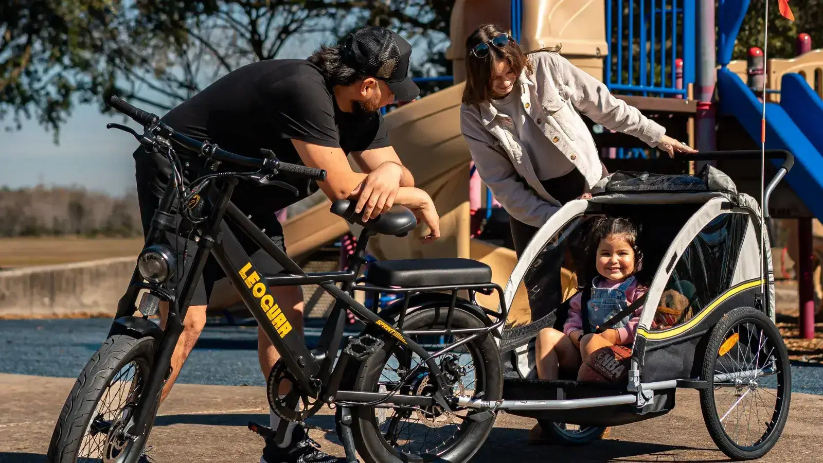 Family enjoying the best electric bike with kid seat at a park, highlighting safety and fun in outdoor activities.