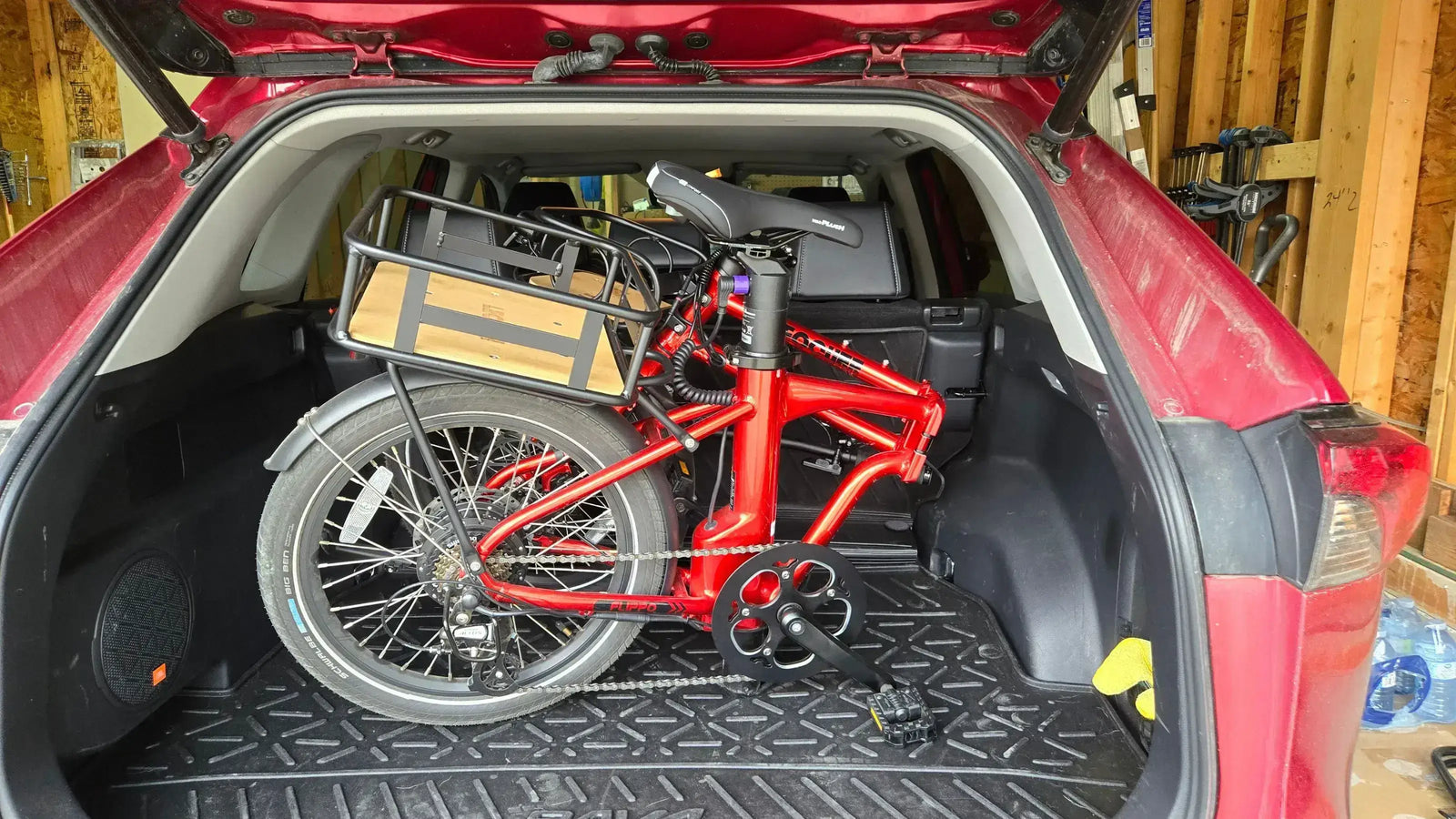 Foldable lightweight ebike packed in SUV trunk for easy transportation