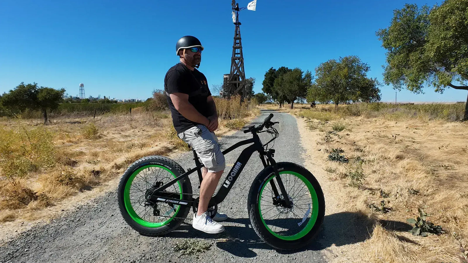 Rider on a Leoguar fat tire electric bike on a dirt trail, demonstrating off-road performance and stability.