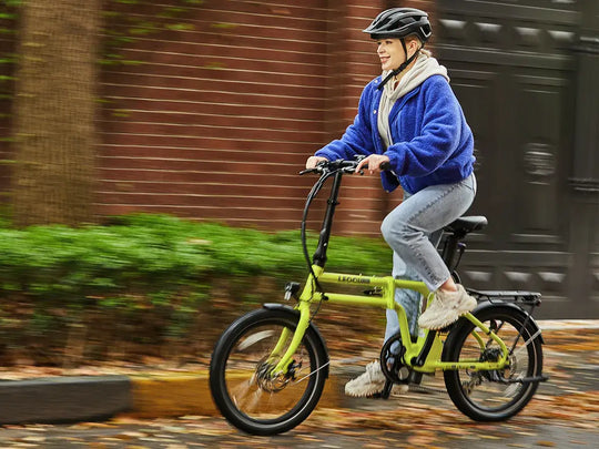 Woman riding a foldable ebike outdoors