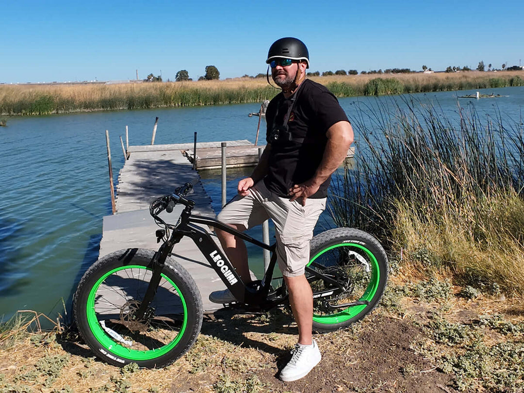 Green-rimmed Fastron SO fat tire ebike with upright geometry, angled view