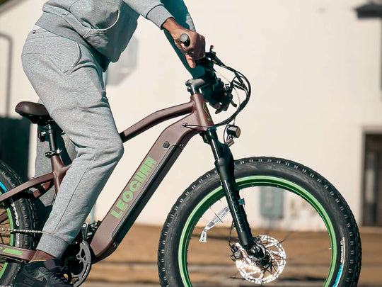 Close-up of rider pedaling Fastron SO e-bike with fat tires and rugged motor hub