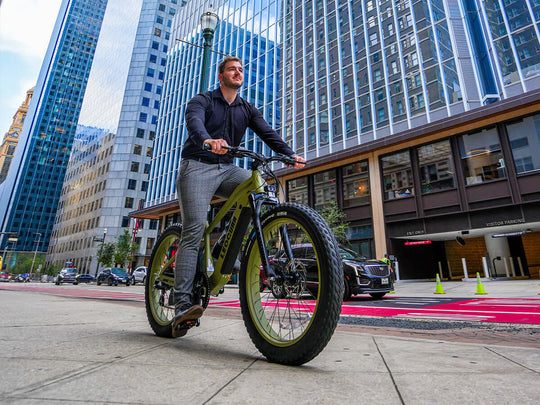 Two Fastron SO ebikes parked in front of modern city buildings, urban riding scene