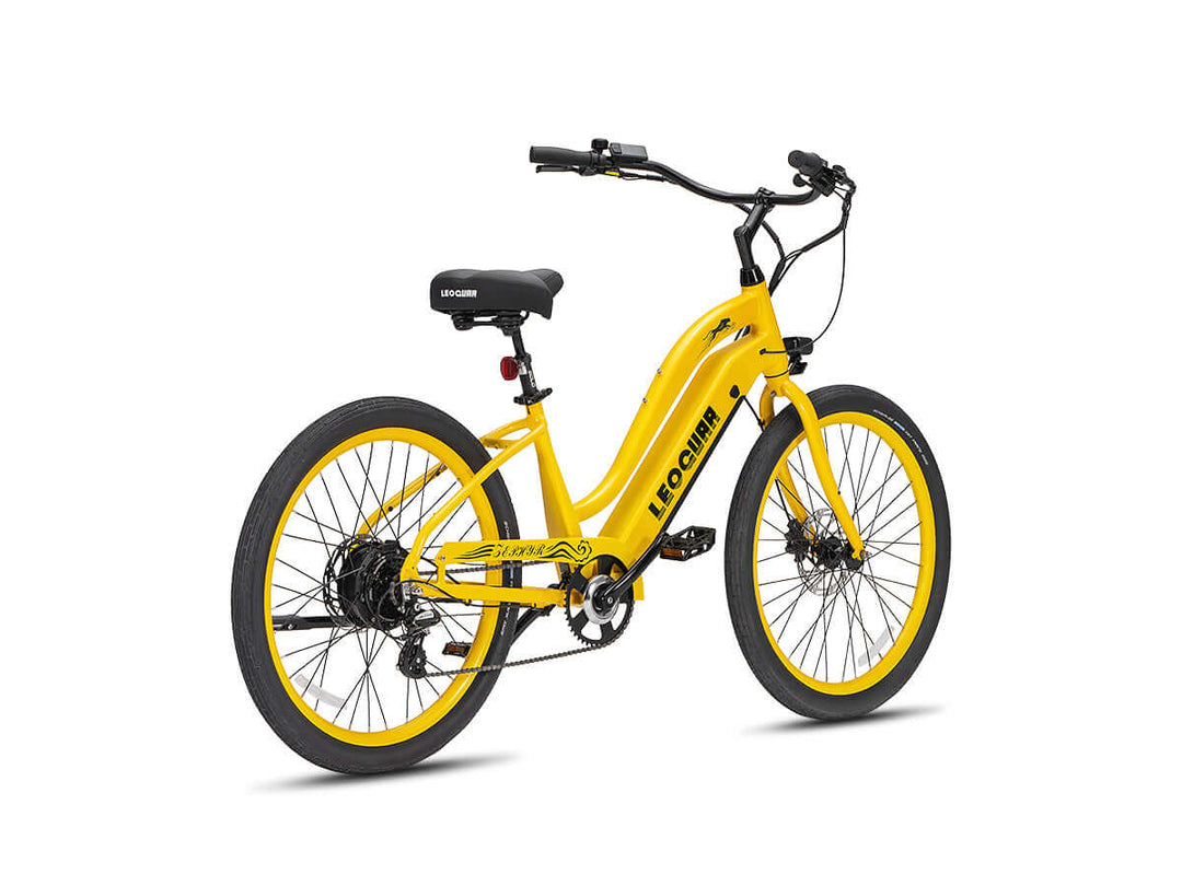 Rear-side view of a yellow Zephyr ST electric cruiser bike with wide saddle and beach-ready tires.